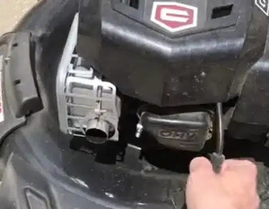Removing the spark plug to clean a riding lawn mower deck